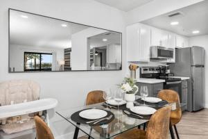 a kitchen and dining room with a table and chairs at Chill 2BR Near ASU, Pool, Grill, Parking,Pet Frndly in Tempe