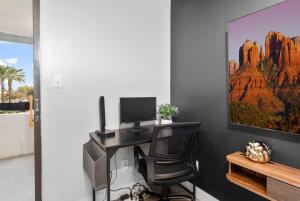 a desk with a computer and a chair in a room at Chill 2BR Near ASU, Pool, Grill, Parking,Pet Frndly in Tempe