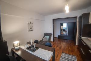 a living room with a table and a dining room at M-Buf Center Apartament in Gura Humorului