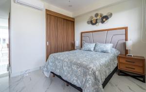 a bedroom with a large bed and a nightstand with a bed sidx sidx sidx at Nuevo Vallarta Peaceful Loft in Nuevo Vallarta +5 photos