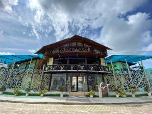 a building with a gate in front of it at Hotel Puerto Gaviota in Tonsupa