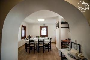 a dining room with a table and chairs at Limbus Fogadó in Gyöngyöstarján