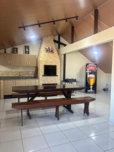 a ping pong table in a room with a fireplace at Sobrado in Curitiba