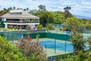 a tennis court in front of a building at Grand Champions 185 in Wailea