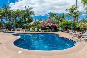 a swimming pool with chairs and umbrellas at a resort at Grand Champions 185 in Wailea +35 photos