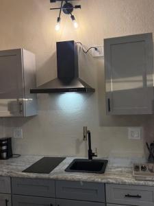 a kitchen with a sink and a stove at Peaceful Studio Retreat Near Shoal Bay Beach in Shoal Bay Village