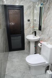 a bathroom with a toilet and a sink at EKA Resort in Goris