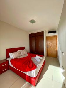 a bedroom with a red bed with a red blanket at Atlas Ocean View Vue Mer Directe in Aourir