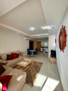 a living room with a couch and a table at Atlas Ocean View Vue Mer Directe in Aourir