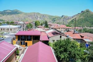 a town with red roofs and mountains in the background at EKA Resort in Goris