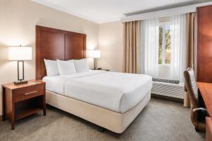 a hotel room with a large bed and a window at Comfort Inn Columbia Gorge in The Dalles +12 photos