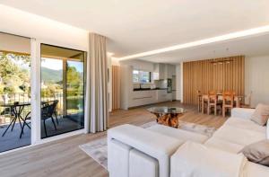 a living room with a white couch and a table at Serração House in Rio Caldo