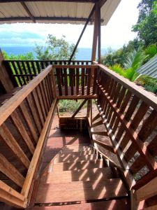 a wooden deck with a view of the ocean at Cumbilinchero Selva Mojada in Nuquí