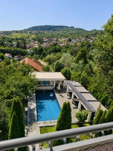 an aerial view of a house with a swimming pool at Nature Bliss Villa in Sarajevo