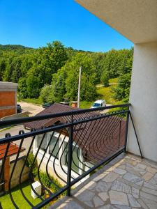 a balcony of a building with a car in the background at Nature Bliss Villa in Sarajevo
