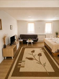a living room with a bed and a couch at Nature Bliss Villa in Sarajevo