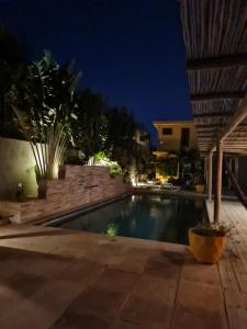 a swimming pool in a backyard at night at Casa Bea in Fortim +12 photos