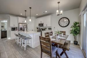 a kitchen and dining room with a table and a clock at Desert Oasis in Washington