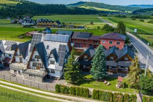 an aerial view of a house with solar panels on it at DW KINGA Domki całoroczne 6 os z widokiem na Tatry in Kacwin