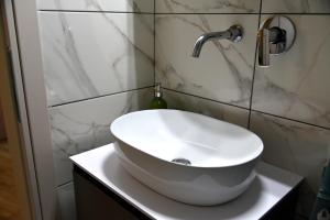 a bathroom with a white sink on a counter at ANNA's House in Mythimna