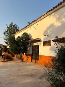 a building with a sign on the side of it at Cuevas Uropia in Graena