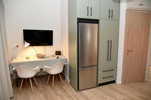 a kitchen with a table and a refrigerator at ANNA's House in Mythimna