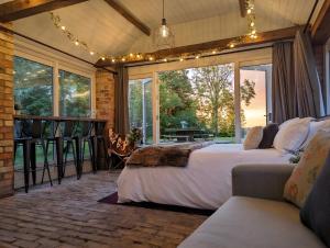 a bedroom with a bed and a large window at The Old Forge in Bishop Wilton
