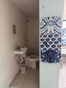 a bathroom with a toilet and a sink at HM cuarteria cangrejos in Cabo San Lucas