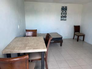 a dining room with a table and chairs and a couch at HM cuarteria cangrejos in Cabo San Lucas