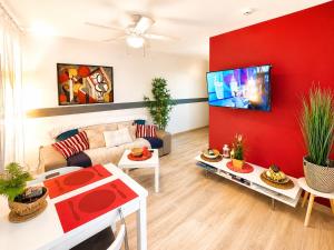 a living room with a couch and a tv at Solymar Premium Apartment 2 in Playa del Ingles