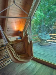 a hammock hanging in a room with a porch at Mountain heaven in Andrijevica +20 photos