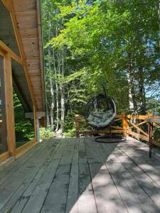a porch of a house with a bench and trees at Mountain heaven in Andrijevica