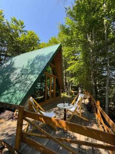 a cabin with a table and chairs on a deck at Mountain heaven in Andrijevica