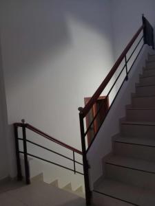 a staircase in a building with a metal railing at La Clandestina in Chachagüí