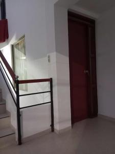 a room with a door and a staircase and a stair case at La Clandestina in Chachagüí