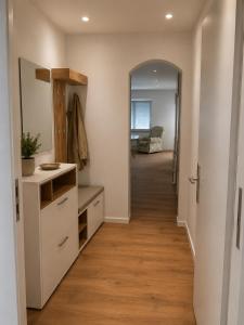 an empty hallway with a hallway leading to a room with a mirror at Ferienwohnung Bayer in Gründau