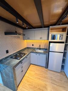a kitchen with white cabinets and a white refrigerator at Villa Royal in Imperatriz +14 photos