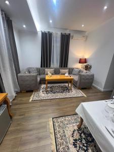 a living room with a couch and a table at Villa Prince in Goranxi +8 photos