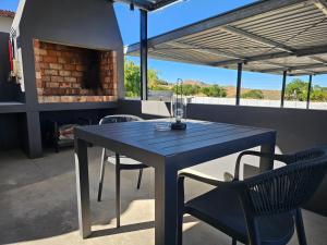 a blue table and chairs on a patio at Rosa's Self-catering Unit 2 in Springbok