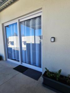 a glass door to a building with a view of the ocean at Rosa's Self-catering Unit 2 in Springbok