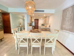 a dining room with a white table and chairs at Charming two-bedroom apartment in Las Terrenas in Las Terrenas