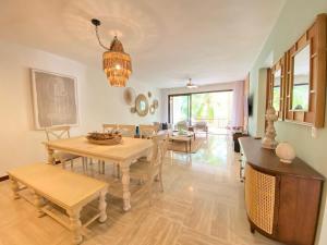 a living room with a table and chairs and a chandelier at Charming two-bedroom apartment in Las Terrenas in Las Terrenas