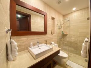 a bathroom with a sink and a mirror and a shower at Charming two-bedroom apartment in Las Terrenas in Las Terrenas