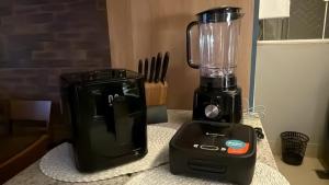 a blender sitting on a counter next to a toaster at Apartamento ao lado do Mercado Central Edifício Fidelis in Goiânia +8 photos