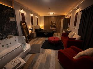 a living room with a bath tub and a living room with a couch at Vera Suite Hotel in Istanbul