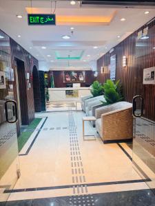 a lobby with a couch and a table in a building at Rahat Alubur Hotel in Medina