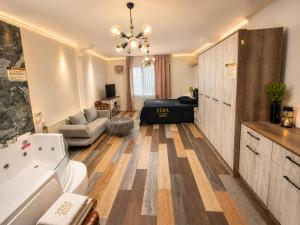 a bathroom with a tub and a living room at Vera Suite Hotel in Istanbul