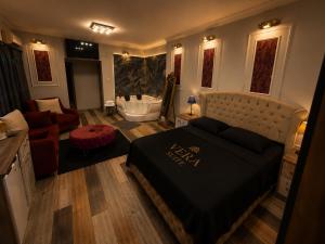 a bedroom with a large bed and a bath tub at Vera Suite Hotel in Istanbul