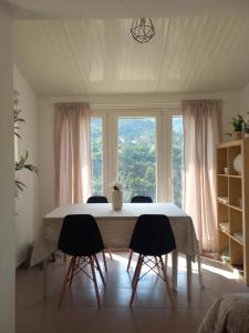 a dining room table with chairs in front of a window at Poço Cávado House T3 in Geres