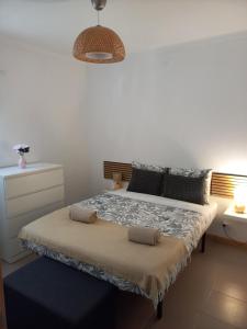 a bedroom with a bed with two pillows at Poço Cávado House T3 in Geres